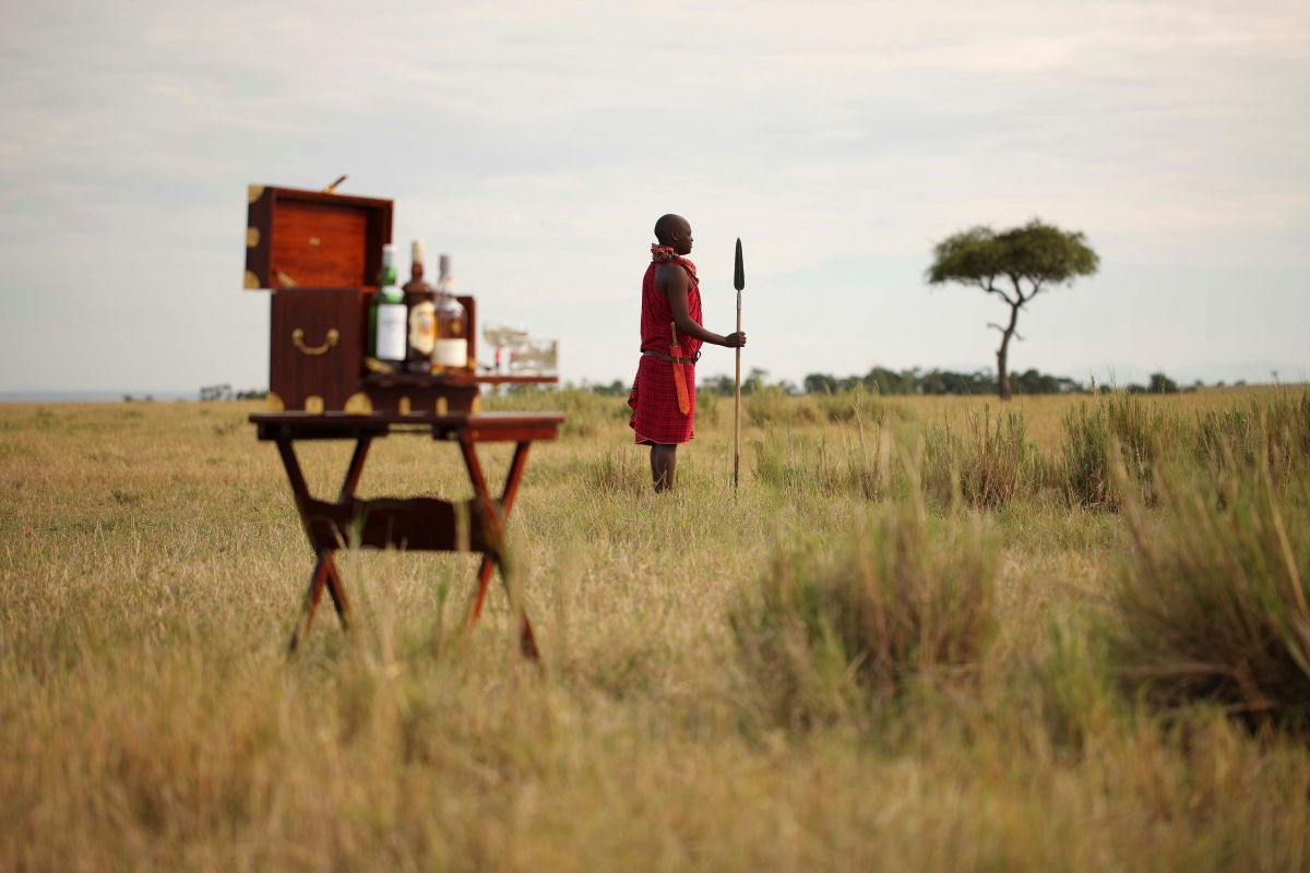 Elewana-Elephant-Pepper-Camp-maasai-mara-lodges-sundowner-stop Maasai warrior waiting to welcome guests for a bush sundowner after their game drive