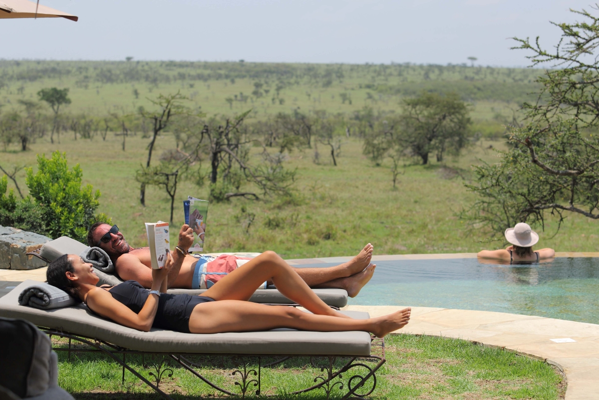 Naboisho-camp-maasai-mara-pool-area Guests relaxing by the camp's main pool
