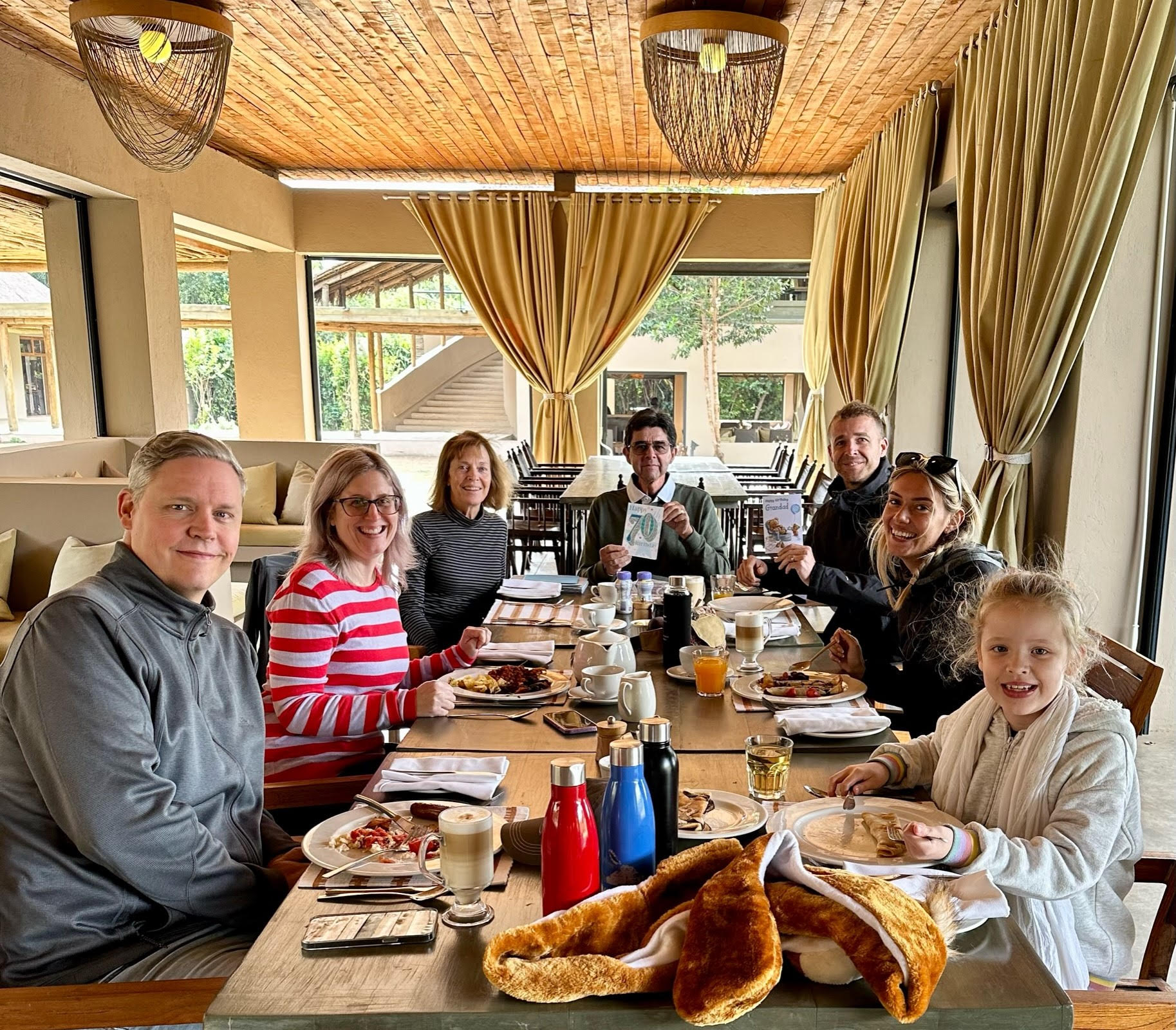 Eddie-Fazal-family-photo-Kichwa-Camp Eddie and family at a dinner table celebrating his 70th birthday